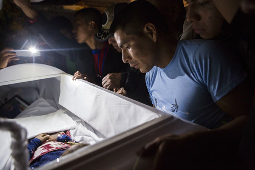 Family members pay their final respects to 7-year-old Jakelin Caal Maquin during a memorial service in her grandparent's home in San Antonio Secortez, Guatemala, Monday, Dec. 24, 2018. [Photo: AP]