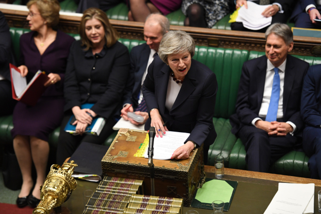 A handout photograph released by the UK Parliament shows Britain's Prime Minister Theresa May speaking during Prime Minister's Questions (PMQs) in the House of Commons in London on January 9, 2019. [Photo: AFP]