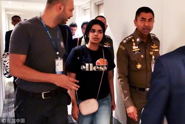 This handout picture taken and released by Thai Immigration Bureau on January 7, 2019 shows 18-year-old Saudi woman Rahaf Mohammed al-Qanun (2nd-L) is being escorted by the Thai immigration officer and United Nations High Commissioner for Refugees (UNHCR) officials at the Suvarnabhumi international airport in Bangkok. [Photo: Thai Immigration Bureau via VCG]