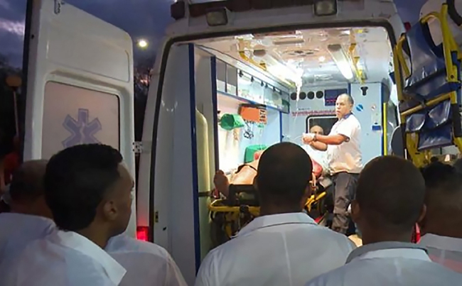 Handout picture released by Cuban official website www.cubadebate.cu showing an ambulance arriving with a wounded person at the provincial hospital of Guantanamo, eastern Cuba, on January 10, 2019 after a bus overturned while driving on the road linking the city of Baracoa, near the island's eastern tip, to the capital Havana. [Photo: www.cubadebate.cu / AFP]