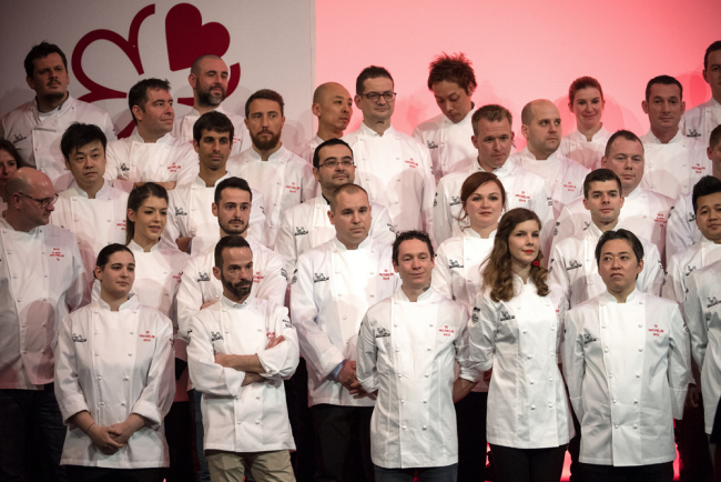 Chefs stand on stage after they were awarded one Michelin star during the Michelin guide award ceremony in Paris on January 21, 2019. [Photo: AFP]