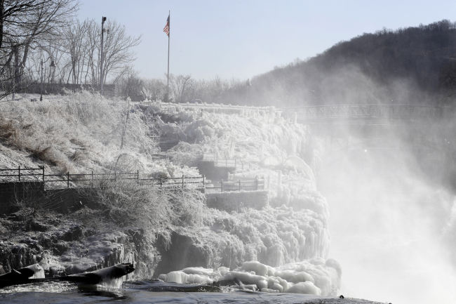 Ice covers the observation area at the Great Falls National Historic Park during a frigid cold winter day, Wednesday, Jan. 30, 2019, in Paterson, N.J. [Photo: AP/Julio Cortez]