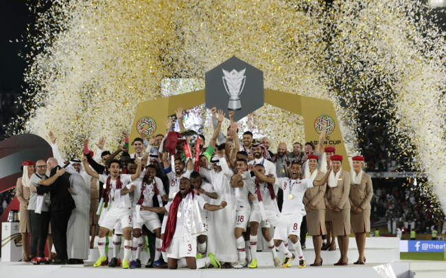 Qatar's forward Hasan Al Haydos, center, lifts the trophy for the winners of the AFC Asian Cup final match between Japan and Qatar in Zayed Sport City in Abu Dhabi, United Arab Emirates, Friday, Feb. 1, 2019. [Photo: AP]