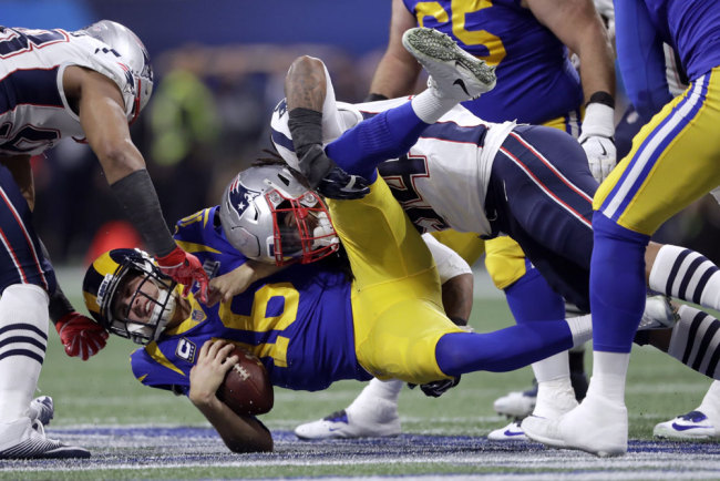 New England Patriots' Dont'a Hightower, top, sacks Los Angeles Rams' Jared Goff (16) during the first half of the NFL Super Bowl 53 football game Sunday, Feb. 3, 2019, in Atlanta. [Photo: AP/John Bazemore]