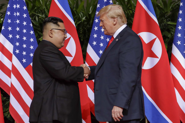 U.S. President Donald Trump shakes hands with North Korea leader Kim Jong Un at the Capella resort on Sentosa Island Tuesday, June 12, 2018 in Singapore. [File photo: AP]