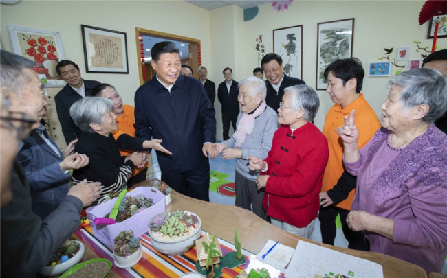 Chinese president Xi Jinping talks with some aged people in Hongkou district in Shanghai. [Photo: Xinhua]