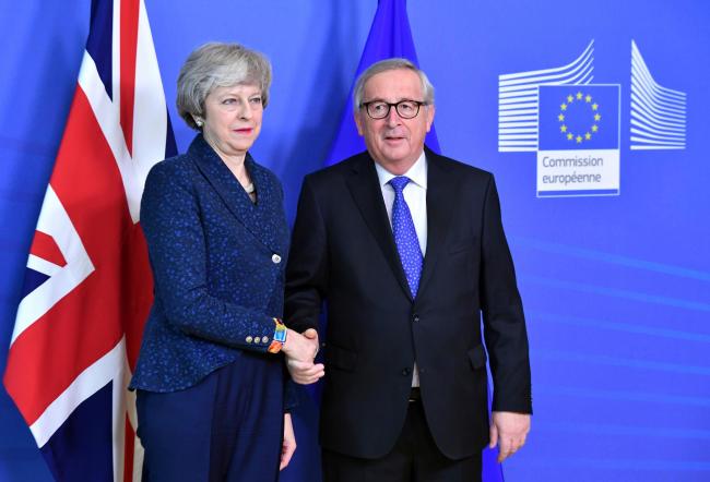 European Commission President Jean-Claude Juncker shakes hands with British Prime Minister Theresa May before their meeting at the European Commission headquarters in Brussels, Thursday, Feb. 7, 2019. [Photo: AP /Geert Vanden Wijngaert]