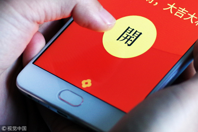 Paper red envelop of lucky money are being replaced by electric money transfers via smartphones. [Photo: VCG]
