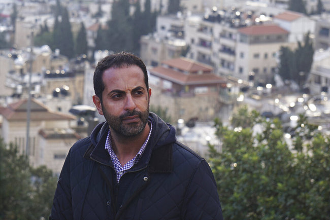 Lawyer Alaa Mahajna poses for a photo on Mount Scopus, overlooking Jerusalem, on Saturday, Feb. 9, 2019. Mahajna was one of at least half a dozen people targeted by a mysterious group of undercover operatives over the past couple of months. All of them have crossed paths, in some way, with the NSO Group, a spyware maker that Mahajna is suing in Israeli court. [Photo: AP]