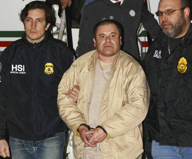 In this Jan. 19, 2017 photo provided by the United States Drug Enforcement Administration, authorities escort Joaquin "El Chapo" Guzman, center, from a plane to a waiting caravan of SUVs at Long Island MacArthur Airport in Ronkonkoma, N.Y. The notorious Mexican drug lord was convicted of drug-trafficking charges, Tuesday, Feb. 12 2019, in federal court in New York. [Photo: AP]