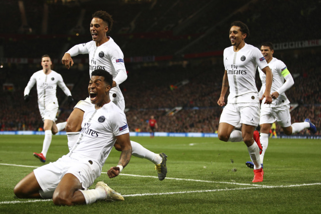 Paris Saint Germain's Presnel Kimpembe, left, celebrates after scoring the opening goal the game during the Champions League round of 16 soccer match between Manchester United and Paris Saint Germain at Old Trafford stadium in Manchester, England, Tuesday, Feb. 12,2019. [Photo: AP]