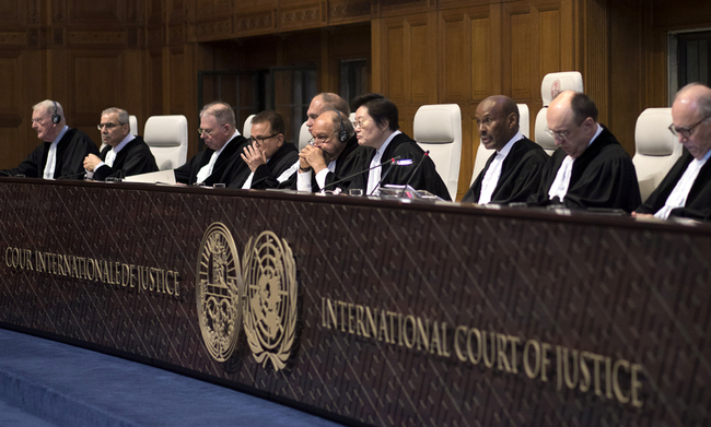 Presiding judge Abdulqawi Ahmed Yusuf of Somalia, third from right, reads the court's verdict as delegations of Iran and the U.S. listen at the International Court of Justice, or World Court, in The Hague, Netherlands, Feb. 13, 2019. [Photo: AP/Peter Dejong]