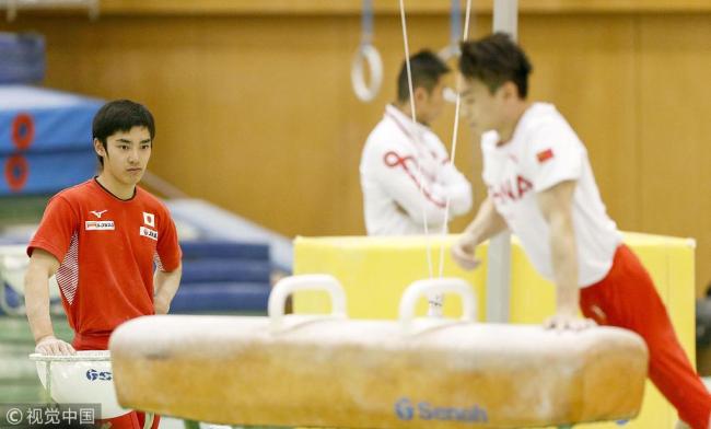 Japanese gymnast Kenzo Shirai (L) is pictured during a Japan-China joint training camp at the National Training Center in Tokyo on Feb. 13, 2019. [Photo: Kyodo via VCG]