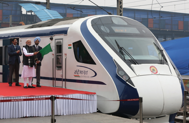 In this photo taken on February 15, 2019, Indian Prime Minister Narendra Modi (2nd L) flags off India's first semi-high speed express train Vande Bharat Express at New Delhi Railway Station. India's first semi-high speed express train February 16 broke down on the tracks for hours after it crashed into cattle, a day after being flagged off by Prime Minister Narendra Modi.[Photo: AFP/STR]
