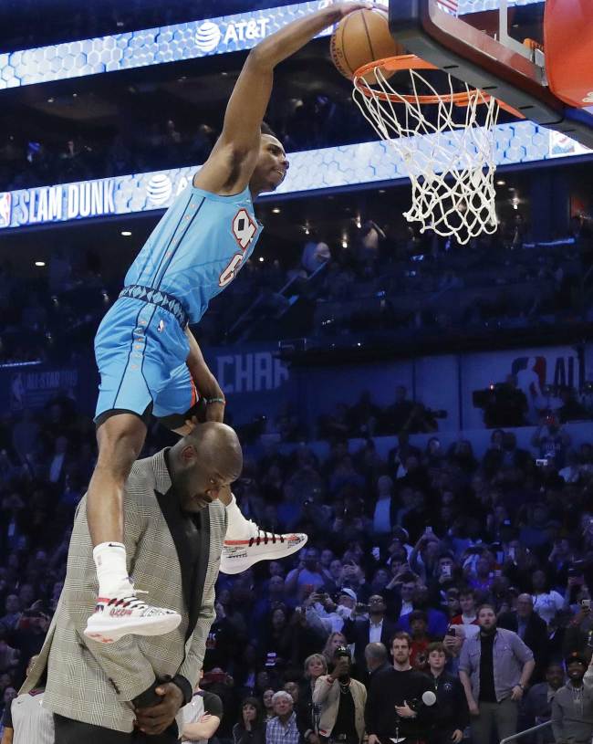 Oklahoma City Thunder Hamidou Diallo leaps over former NBA player Shaquille O'Neal during the NBA All-Star Slam Dunk contest, Saturday, Feb. 16, 2019, in Charlotte, N.C. Diallo won the contest. [Photo: AP/Chuck Burton]