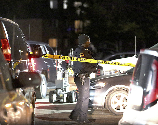 Authorities search an apartment complex Friday, Feb. 15, 2019, in Aurora, Ill., where the gunman who fatally shot several people at a manufacturing complex in the city is believed to have lived. [Photo: AP/Patrick Kunzer/Daily Herald]