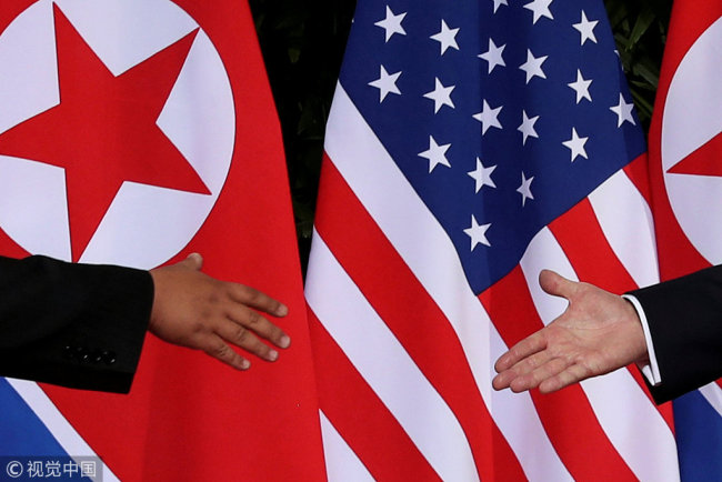 U.S. President Donald Trump and North Korea's leader Kim Jong Un meet at the start of their summit at the Capella Hotel on the resort island of Sentosa, Singapore June 12, 2018. [File Photo: VCG]