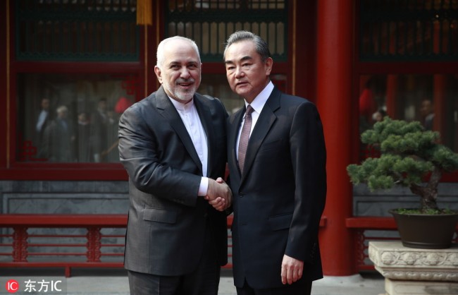 Iranian Foreign Minister Mohammad Javad Zarif, left, and his Chinese counterpart Wang Yi shake hands during their meeting at the Diaoyutai State Guesthouse in Beijing Tuesday, Feb. 19, 2019. [Photo: IC]