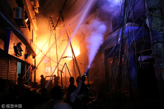 Firefighters work at the scene of a fire that broke out at a chemical warehouse in Dhaka, Bangladesh February 21, 2019. [Photo: VCG]