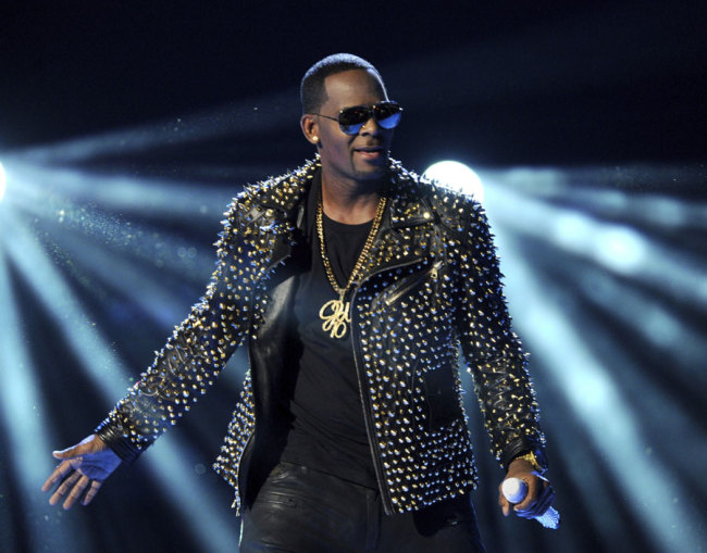 In this June 30, 2013 file photo, R. Kelly performs at the BET Awards in Los Angeles. Prosecutors will have to clear a series of high legal hurdles if they intend to charge R. Kelly anew and convict him, even if video evidence is available. Speculation the R&B star could face new charges arose after attorney Michael Avenatti said Thursday, Feb. 14, 2019, he recently gave prosecutors a VHS tape showing Kelly having sex with an underage girl. [File Photo: Frank Micelotta/Invision/AP]