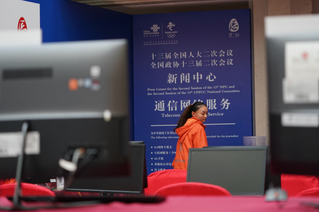 People work at the Press Center set up for the Two Sessions in Beijing on Wednesday, February 27, 2019. [Photo: China Plus/Li Jin]