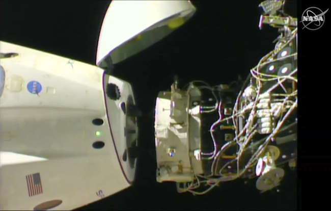 In this image taken from NASA Television, SpaceX's swanky new crew capsule undocks from the International Space Station Friday, March 8, 2019. The capsule undocked and is headed toward an old-fashioned splashdown. The Dragon capsule pulled away from the orbiting lab early Friday, a test dummy named Ripley its lone occupant. [Photo: NASA TV via AP]