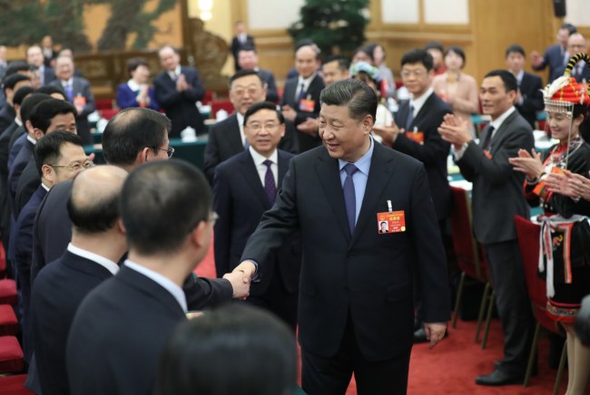 Chinese President Xi Jinping shakes hands with deputies from Fujian Province at the second session of the 13th National People's Congress in Beijing, March 10, 2019. [Photo: Xinhua]