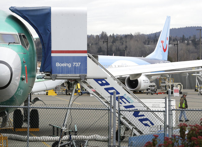 In this photo taken Monday, March 11, 2019, a Boeing 737 MAX 8 airplane being built for TUI Group sits parked in the background at right at Boeing Co.'s Renton Assembly Plant in Renton, Wash. Britain, France and Germany on Tuesday joined a rapidly growing number of countries grounding the new Boeing plane involved in the Ethiopian Airlines disaster or turning it back from their airspace, while investigators in Ethiopia looked for parallels with a similar crash just five months ago. [Photo: AP]