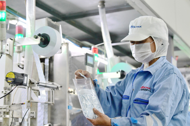 A staff member works at a factory producing food preservatives in Hai’an, Jiangsu Province on July 1, 2018. [File photo: IC]