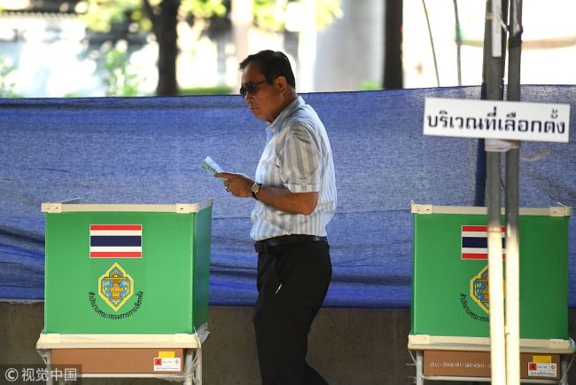 Thai Prime Minister Prayut Chan-O-Cha holds his ballot during voting at a polling station in Bangkok on March 24, 2019 during Thailand's general election. [Photo: VCG]