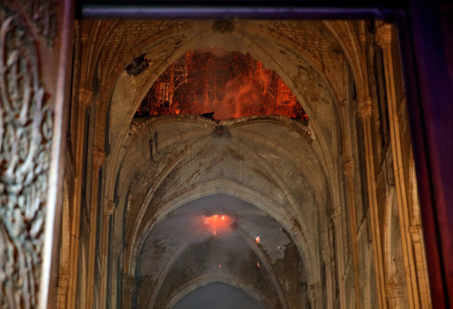 Flames and smoke are seen as the interior of the Notre-Dame Cathedral continues to burn on April 15, 2019, in the French capital Paris. [Photo: AFP]