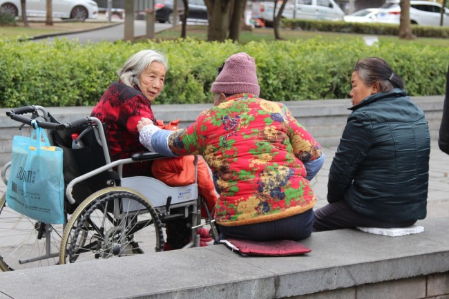 People rest at an elderly care center in Yunyang County, Chongqing Municipality, on March 9, 2019. [Photo: IC]