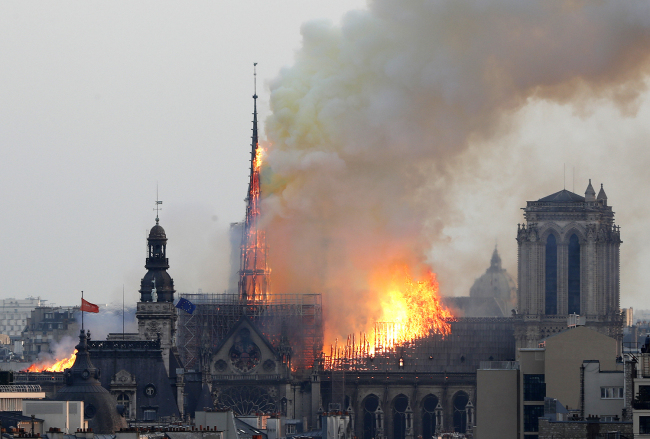 Flames rise from Notre Dame Cathedral as it burns in Paris, Monday, April 15, 2019. [Photo: AP/Thibault Camus]