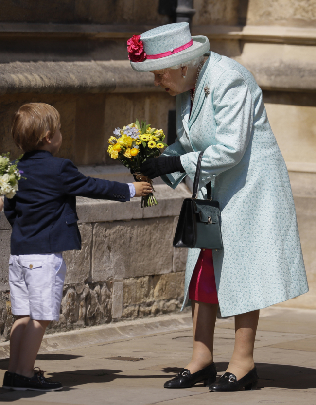 Britain's Queen Elizabeth II is presented with flowers as she leaves after attending the Easter Mattins Service at St. George's Chapel, at Windsor Castle in England Sunday, April 21, 2019. [Photo: AP]