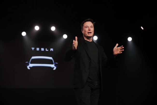 In this March 14, 2019, file photo Tesla CEO Elon Musk speaks before unveiling the Model Y at Tesla's design studio in Hawthorne, Calif. Musk appears poised to transform the company’s electric cars into driverless vehicles in a risky bid to realize a bold vision that he has been floating for years. The technology required to make that quantum leap is scheduled to be shown off to Tesla investors Monday, April 22, 2019, at the company’s Palo Alto, Calif., headquarters. [File Photo: AP/Jae C. Hong]