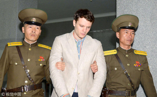 American student Otto Frederick Warmbier (C) is escorted out of the courtroom after his trial in Pyongyang, capital of the Democratic People's Republic of Korea (DPRK), on March 16, 2015. Otto Frederick Warmbier was sentenced to 15 years of hard labor for anti-DPRK crimes in March 2016. [File Photo: VCG]