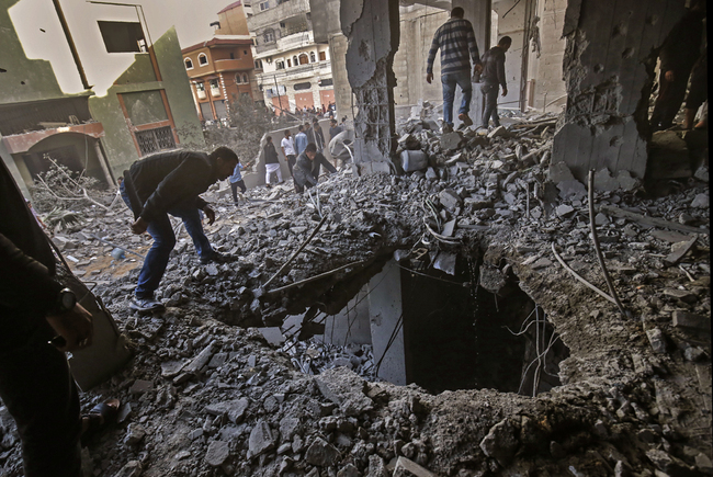 Palestinians check the damage in a destroyed building following Israeli airstrikes, targeting Rafah in the southern Gaza Strip on May 5, 2019. [File Photo: AFP]