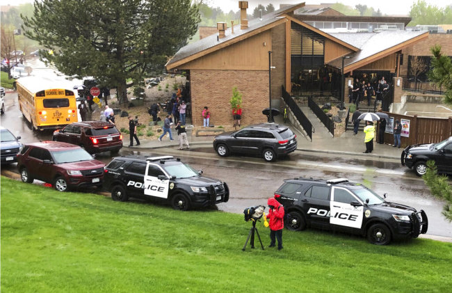 Police and others are seen outside a recreation center where students are reunited with their parents, in the Denver suburb of Highlands Ranch, Colo., after a shooting at STEM School Highlands Ranch Tuesday, May 7, 2019. [Photo: AP]