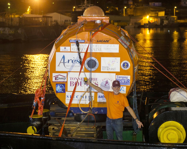 Frenchman Jean-Jacques Savin, who floated across the Atlantic in a custom-made barrel for nearly 100 days, stands next to his barrel aboard the ship "Friendship" after being brought back to land in Fort-de-France, on the French Caribbean island of Martinique, on May 9, 2019. [Photo: AFP/Lionel Chamoiseau]