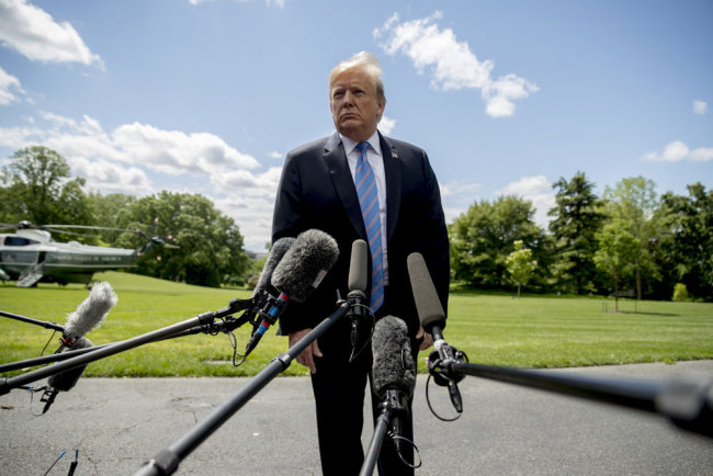 President Donald Trump listens to a question from a member of the media on the South Lawn of the White House in Washington, Tuesday, May 14, 2019, before boarding Marine One for a short trip to Andrews Air Force Base, Md., to travel to Louisiana. [Photo: AP/Andrew Harnik]