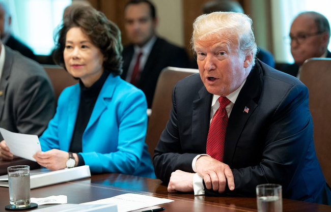 US President Donald Trump speaks alongside Secretary of Transportation Elaine Chao (L) during a cabinet meeting in the Cabinet Room of the White House in Washington, DC, October 17, 2018. [File photo: AFP/Saul Loeb]