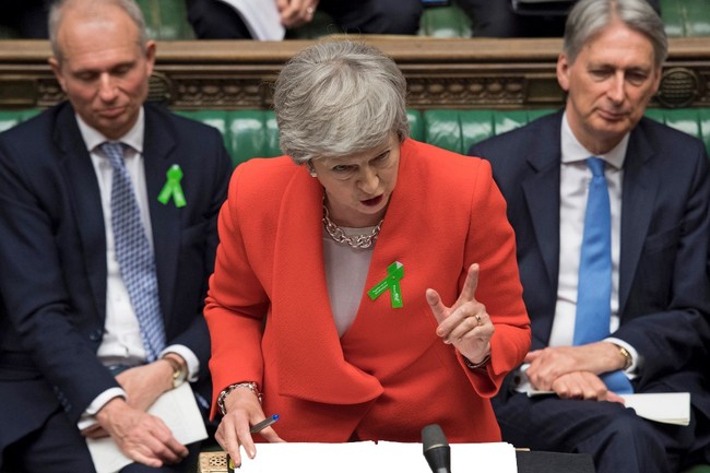 Britain's Prime Minister Theresa May speaking (C), during the weekly Prime Minister's Questions (PMQs) question and answer session in the House of Commons in London. [Photo: AFP/UK Parliament]