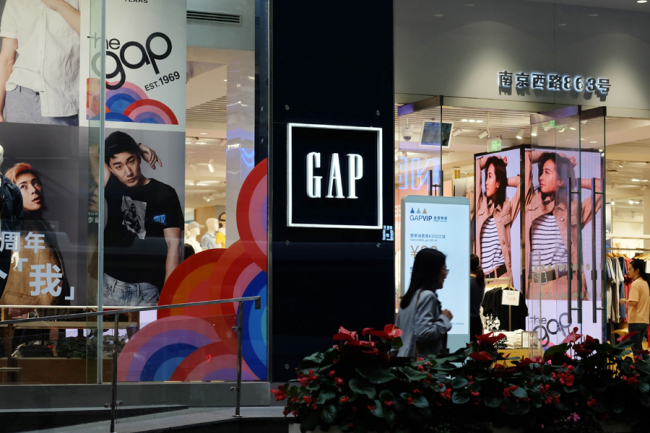 A Chinese consumer passing by a GAP store in Shanghai, May 18, 2019. [Photo: IC]
