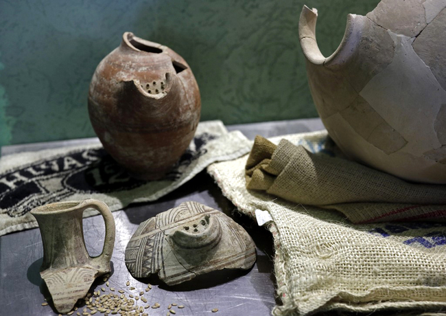 This picture taken on May 22, 2019 shows ancient amphoras showcased during a press conference in Jerusalem, where Israeli researchers announced that they had managed to produce beer made with a yeast that descended from one some 3,000 years old, similar to that produced in the time of the Pharaohs. [Photo: AFP/Thomas Coex]