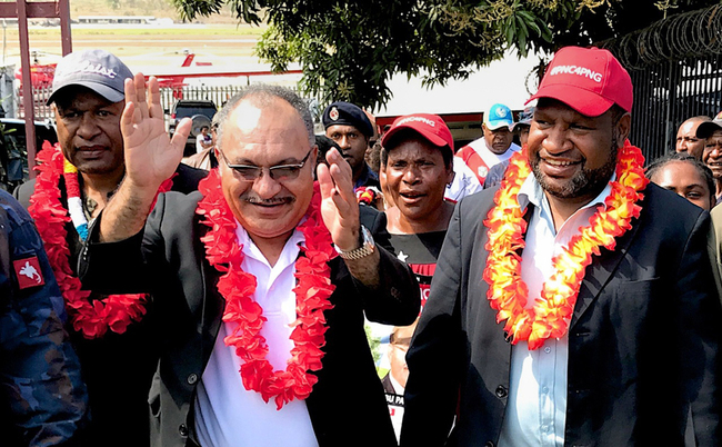 This handout photo taken on July 16, 2017 and received from the Office of the Prime Minister of Papua New Guinea shows Petrus Thomas (L), new member for Koroba-Kopiago Open, Papua New Guinea Prime Minister Peter O'Neill (C) and Finance Minister James Marape (R) being welcomed as O'Neill returns to Port Moresby. [File photo: Office of the Prime Minister Papua New Guinea/AFP/Christopher Hawkins]