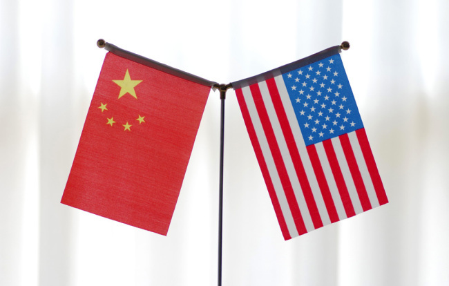 National flags of China and the United States are seen in Ji'nan, Shandong Province, June 14, 2018. [Photo: IC]