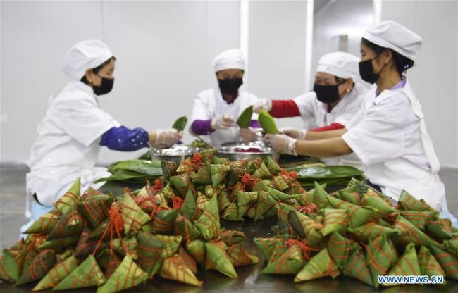 Workers make colorful Zongzi, pyramid-shaped dumplings made of glutinous rice wrapped in bamboo or reed leaves, at a factory in Taijiang County, southwest China's Guizhou Province, June 2, 2019.[Photo: Xinhua/Liu Kaifu] 