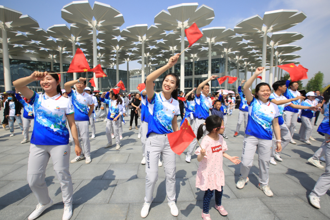 Visitors perform outside the International Pavilion at the Beijing horticultural expo site, in Yanqing District, northwest Beijing, on May 3, 2019. [File Photo: IC]