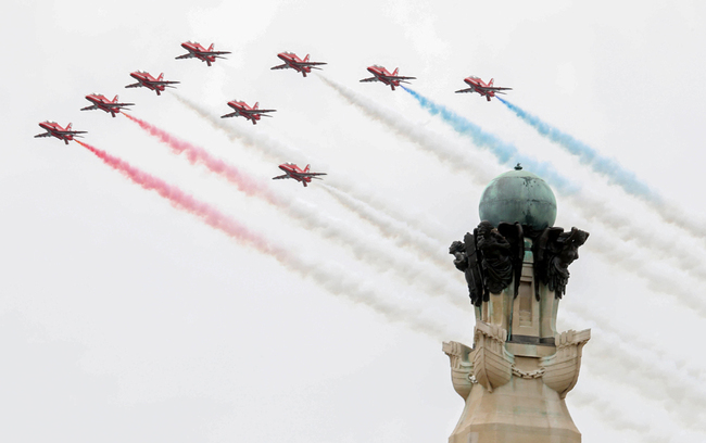 Members of Britain's Red Arrows, the flying display team of the Royal Air Force (RAF) during an event to commemorate the 75th anniversary of the D-Day landings, in Portsmouth, southern England, on June 5, 2019. [Photo: Pool/AFP/Chris Jackson]