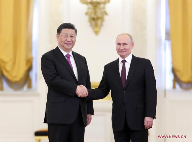 Chinese President Xi Jinping (L) shakes hands with his Russian counterpart Vladimir Putin while posing for photos ahead of their talks in Moscow, Russia, June 5, 2019. Xi Jinping held talks with Vladimir Putin at the Kremlin in Moscow on Wednesday, June 5, 2019. [Photo: Xinhua/Ding Haitao]